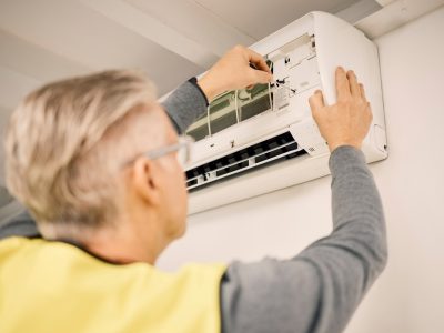 Maintenance, installation and back of a man with air conditioner for service and ac repair. Buildin Maintenance, installation and back of a man with air conditioner for service and ac repair. Buildin